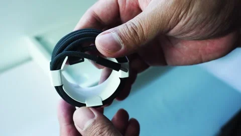 Man Showing Cable From M5 MacBook Pro 14 Inch Stockbeeldmateriaal 334644965