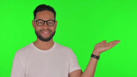 Man Showing Copyspace on Side on Green Background 動画素材 295906301