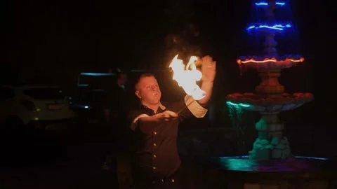 Man is showing dangerous magic tricks with fire and blowing fire from his mouth. Stock Footage 132248813