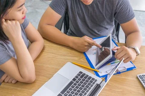 Man showing data in tablet to teammate Stock Photos