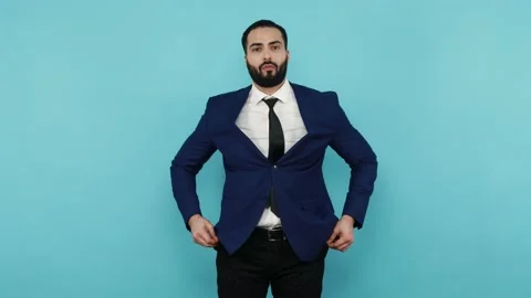 Man showing empty pockets inside out, having no money. Stock Footage 155770761