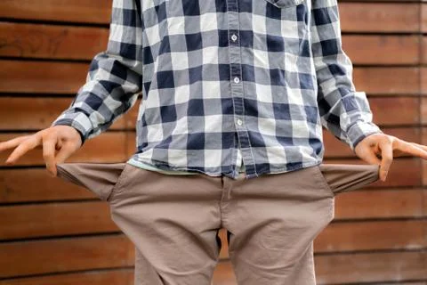 Man showing the empty pockets, poor jobless homeless and moneyless concepts 写真素材
