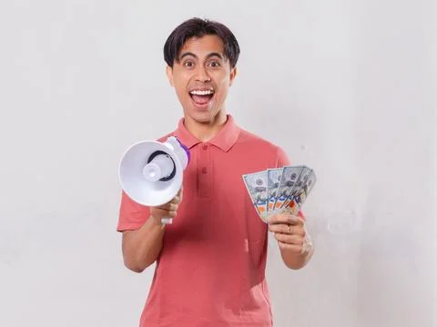 A man showing excited expression while holding megaphone and money Stock Photos