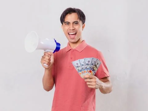 A man showing excited expression while holding megaphone and money Stock Photos