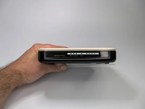 A man is showing the front panel of the WiFi router Stock Photos