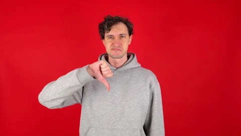 Man showing in front thumb down hand sign dislike gesture 動画素材 304745858