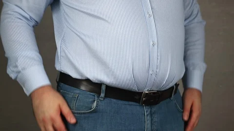 Man showing his empty pockets on grey background Stock Footage 129612571