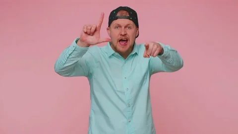 Man showing loser gesture, blaming accusing for unsuccess, disrespect bullying Stock Footage 188334938