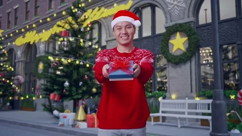 Man Showing A Present And Smiling To The Camera In Christmas Night Stock Footage 278411504