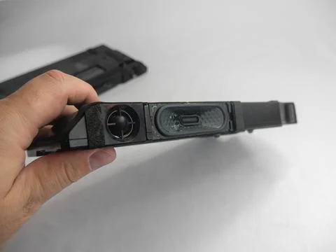 A man is showing a replacement internal speaker for LED TV Stock Photos