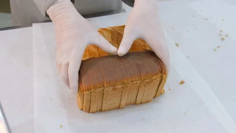 Man showing sliced bread at the manufacturing Stock Footage 131825973