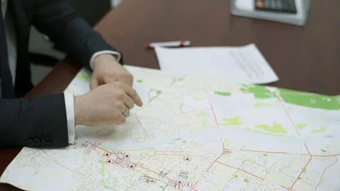 Man showing something on the map Stock Footage 82179869