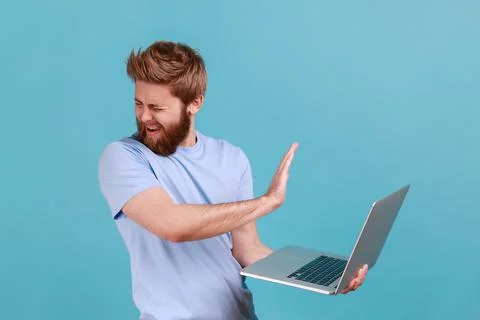 Man showing stop gesture, avoiding watch something unpleasant, forbidden content 写真素材