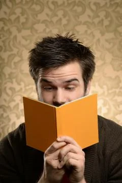 Man Showing Surprise While Reading Stock Photos