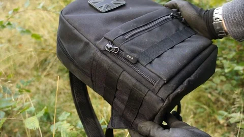 Man showing Survival Backpack in Forest Nature Stock Footage 111856523