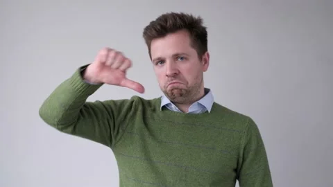 Man showing thumb down sign on white background. Stock Footage 119454907