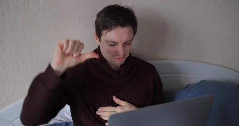 Man showing thumbs down gesture looking in laptop Stock Footage 147595463