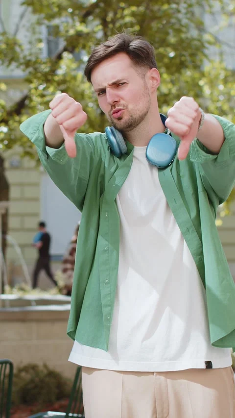 Man showing thumbs down sign dislike expressing discontent disapproval Stock Footage 323365248