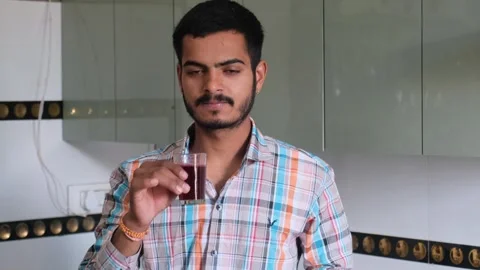 Man showing thumbs up gesture after taking a sip of healthy fresh beetroot juice Видео 329975414