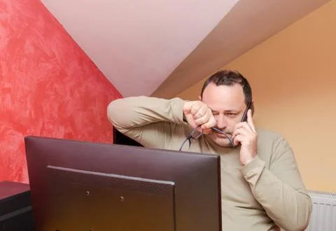 Man showing tiredness by a computer Stock Photos