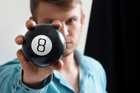 Man shows ball with number to camera. Lucky number or winning lottery Stockfoto's