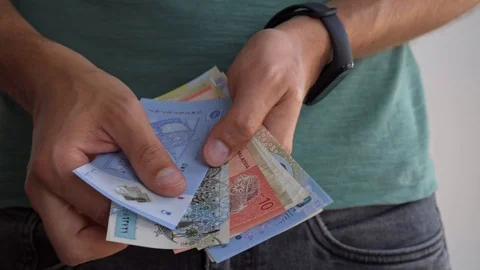 A man shows banknotes of different countries. Stock Footage 115851458