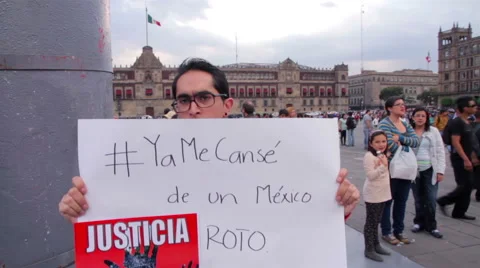 Man shows a banner in a march protest for the students disappeared in Guerrero Stock Footage 44347516