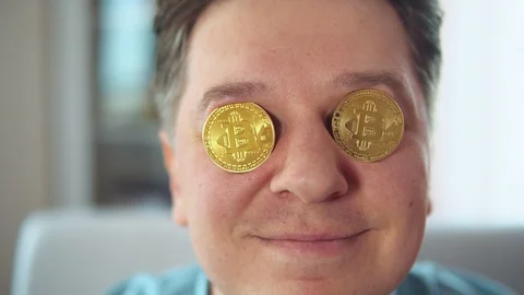 Man shows on the camera bitcoins in the eyes Stock Footage 106540467