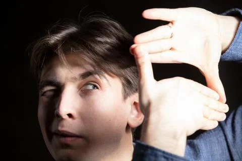 A man shows a camera with a sign Stock Photos