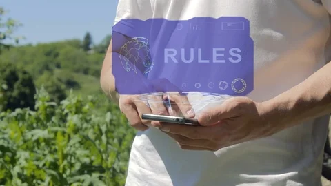 Man shows concept hologram Rules on his phone Stock Footage 98973796