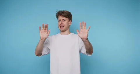 Man shows different hand signals and facial expressions in a studio with a .. Stock Footage 331990892