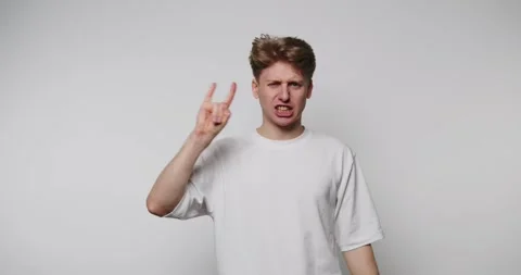 Man shows different hand signs while expressing emotions in a studio settin.. Video stock 328248385