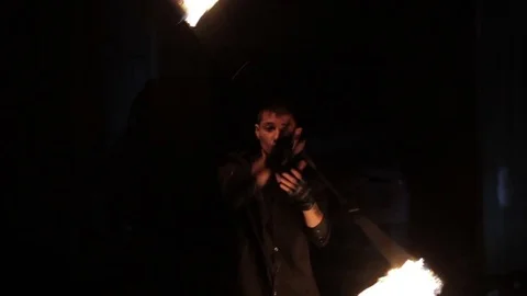 A man shows a fire show in an old aircraft hangar. Stock Footage 79667212