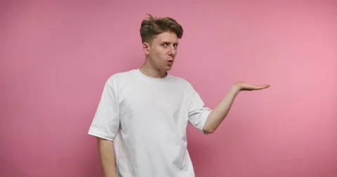 Man shows hand movements in front of pink background in different poses at ho Stock Footage 328246976