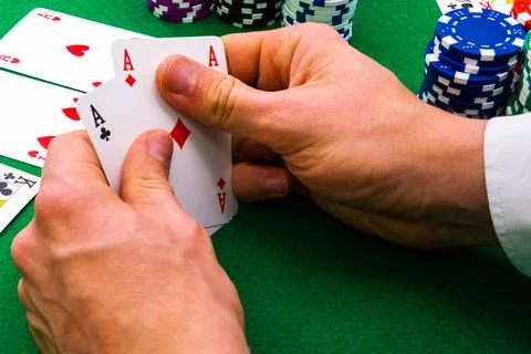 A man shows his deck of aces during a poker game, Stock Photos