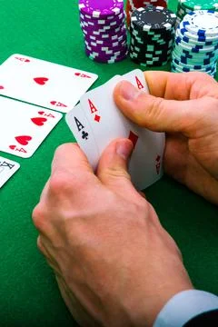 A man shows his deck of aces during a poker game, vertical photo, Stock Photos