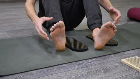 A man shows on his feet marks from sharp nails after standing on the boards of Stock Footage 221867262
