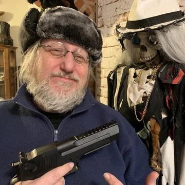 This man shows his gun copy with a smile Stock Photos