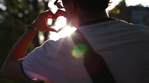 Man shows his hands at sunset heart Video stock 55789478