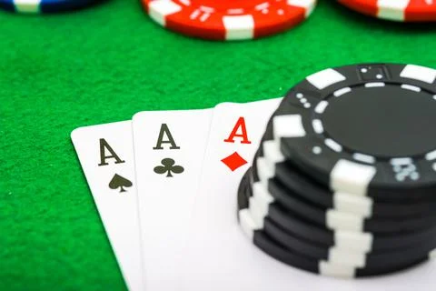 A man shows his three aces during a game of poker, gambling, risk. Stock Photos