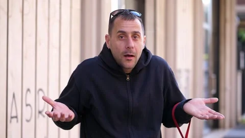 Man shows innocent expression with hand gestures Video stock 308636104