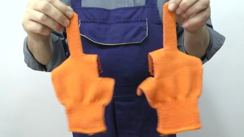 The man shows the middle finger using work gloves. Stock Footage 153894746
