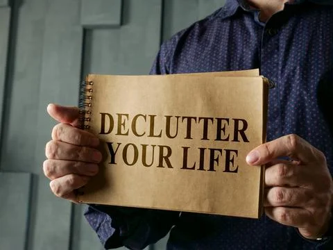 Man shows page with words declutter your life. Stock-Fotos