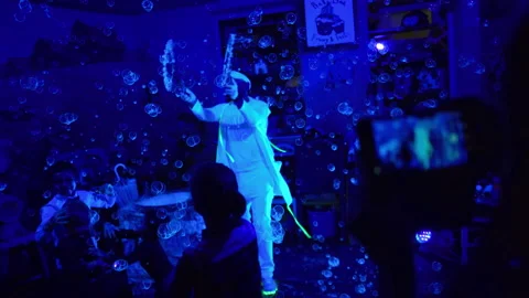 Man shows a performance with soap bubbles for children. Lots of soap bubbles Stock Footage 138936214