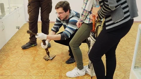 Man shows portable grenade gun made from shovel during tour in historical museum Stock Footage 276368991