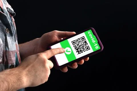 A man shows a qr code in a smartphone containing information about vaccination Stock-Fotos