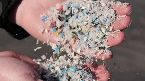 Man Shows Recycled Plastic Pieces In His Hands Stock Footage
