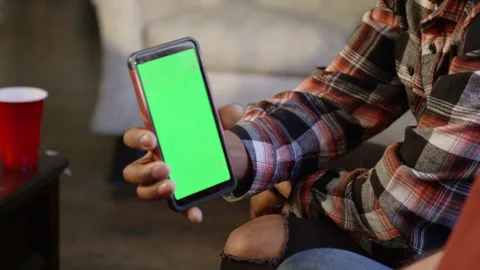 Man Shows Smart Phone Screen with Greenscreen Stock Footage 288534298