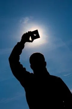 Man shows sun eclipse Stock Photos