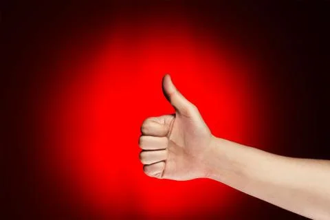 Man shows thumb up over red background Stock Photos